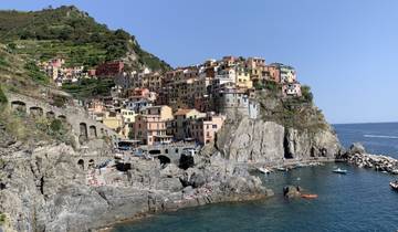 Colorful cliffside buildings in a coastal village.
