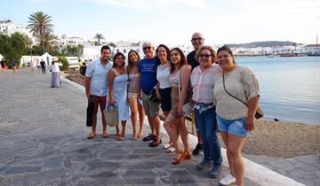 Group of people posing by a waterfront promenade.