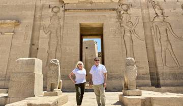 Two people posing in front of an ancient Egyptian temple