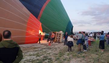 People preparing a hot air balloon for takeoff.