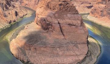 Horseshoe Bend at a river with steep canyon walls.