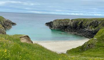 Scenic view of beach with cliffs and clear water