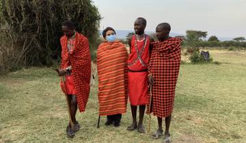 Person in traditional attire with Maasai local guides.
