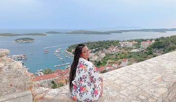 Person overlooking a coastal town and ocean view.