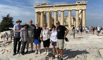 Group of people posing in front of the Parthenon in Athens.