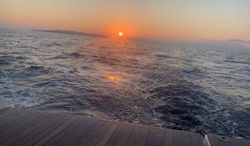 Sunset over the ocean viewed from a boat.