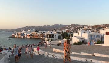 View of a coastal town with white buildings by the sea.