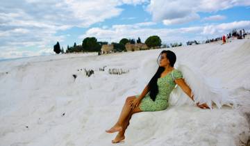 Person sitting on white travertine terraces.