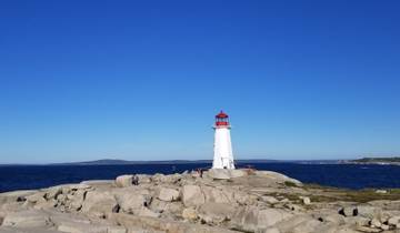 Lighthouse on a rocky coast with the ocean in the background.