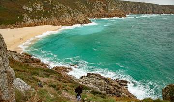 Coastal view with turquoise waters and a sandy beach.