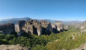 Wide panoramic view of Meteora rock formations.