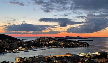 Scenic view of a coastal city during sunset.