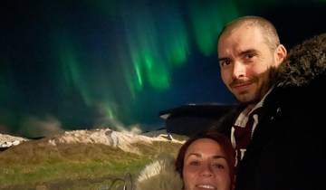 A couple with northern lights in the background