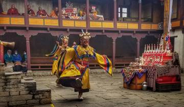 Traditional dance performance with colorful costumes inside a monastery.