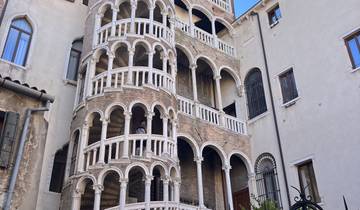 Spiral staircase on the facade of a historic building.