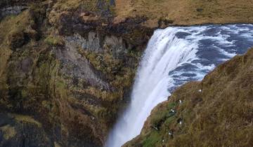 Waterfall cascading into a pool from a steep cliff.