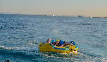 People enjoying a water activity on a yellow inflatable.