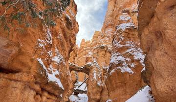 Snow-covered canyon with vibrant rock formations.