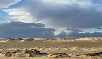 Expansive desert view with dramatic clouds.