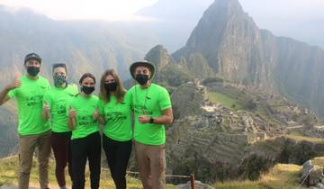 Group posing with matching shirts at Machu Picchu.