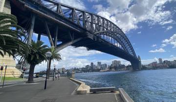 Sydney Harbour Bridge with people walking along the promenade.