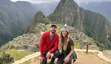 Couple posing in front of Machu Picchu ruins.
