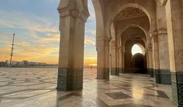 Ornate building with a courtyard and sunset background.