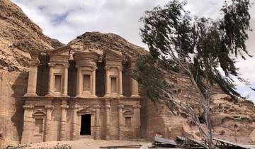 The Monastery, an ancient stone structure with a tree beside it.