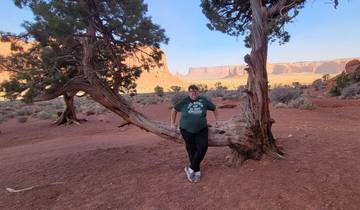 Man posing with a scenic backdrop of Monument Valley.