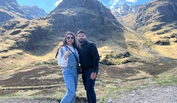 Couple in foreground of Scottish mountains.