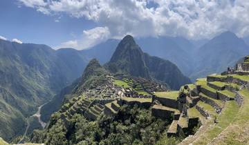 Panoramic view of Machu Picchu surrounded by mountains.