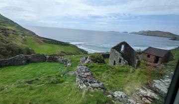 Scenic coastal landscape with old stone walls and green fields.