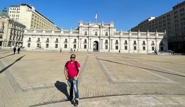 A man standing in front of a historic government building.