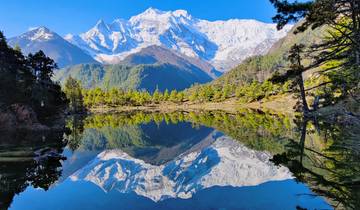 Stunning reflection of snow-capped mountains in a clear lake.