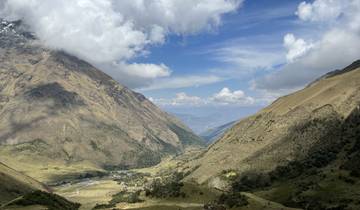 Panoramic view of a valley surrounded by mountains.