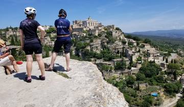 Two cyclists overlooking the village of Gordes.