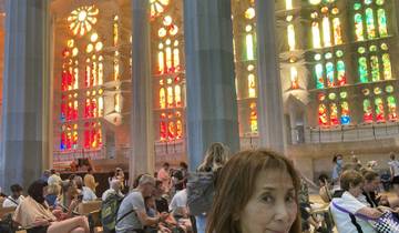 Interior view of a colorful cathedral with people.