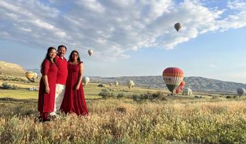 Family posing with hot air balloons in Cappadocia.