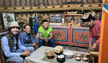 Inside a yurt with people seated around a table