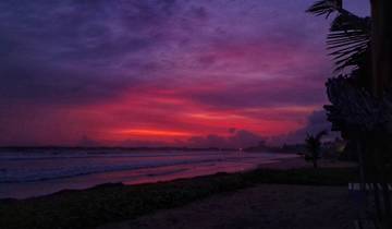 Dramatic sunset over the ocean with striking colors.