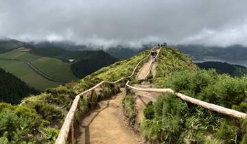 A scenic path on a mountain ridge with people walking.