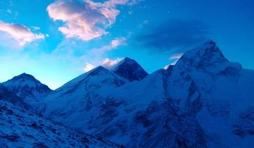 Snow-covered peaks of the Himalayas at dusk.