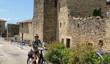 Cyclist in front of old stone buildings