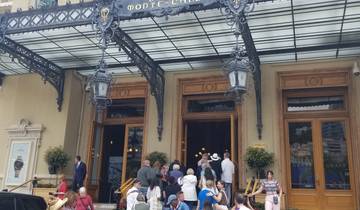 Elegant building entrance with a clock and people milling around.