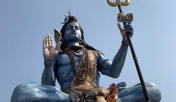 Large statue of a deity holding a trident.