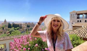 Scenic cityscape with a person and historic buildings in the background.
