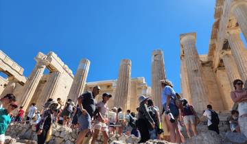 Crowded tourist site with ancient ruins.