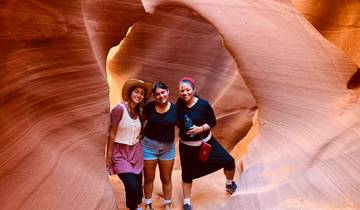 Three women posing in a scenic canyon.