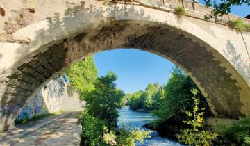Stone bridge over a river with lush greenery