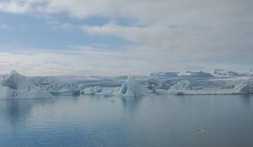 Dramatic icebergs floating in a serene glacial lagoon.